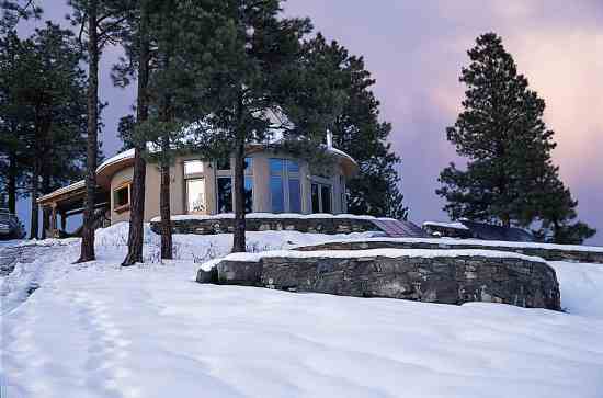 The home is built using fourteen-inch rammed earth bricks and finished with Elastomeric stucco. Twenty-four photovoltaic panels provide for all the Luteses’ power needs.